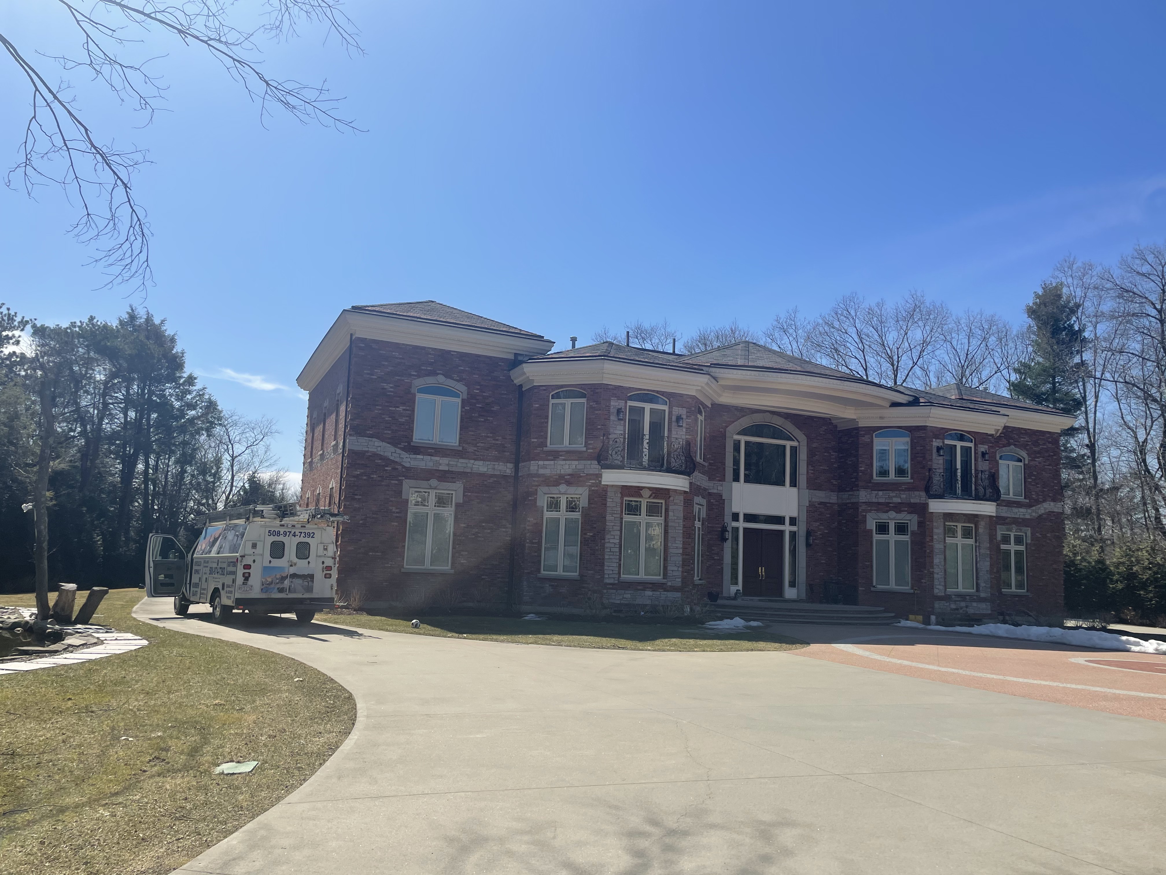 Brick colonial home exterior in Newton, MA served by Storm King Roofing