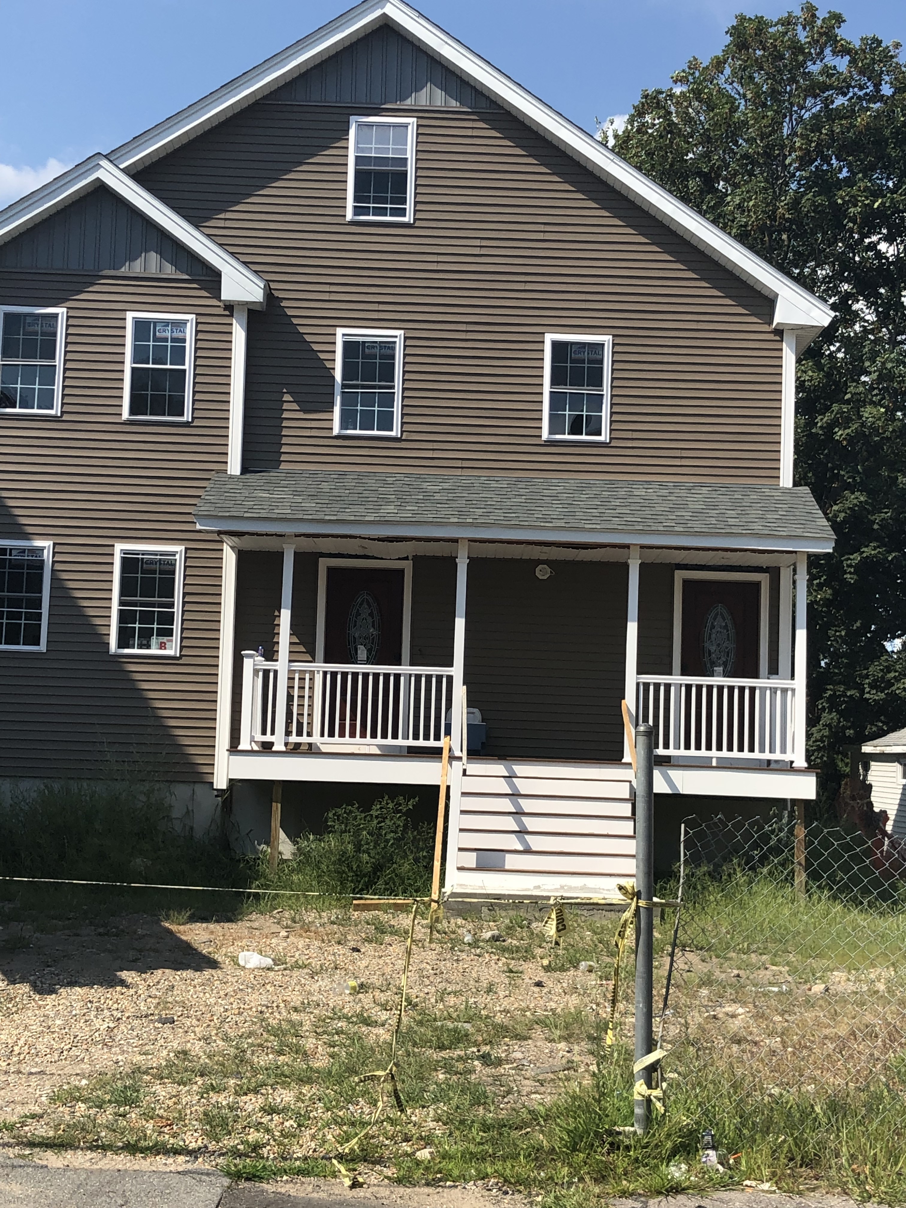 Multi-story home exterior in Brockton, MA serviced by Storm King Roofing