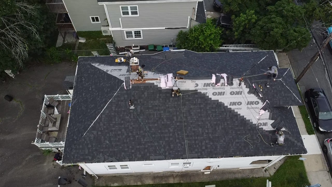 Aerial inspection of a shingle roof on a Braintree, MA home by Storm King Roofing