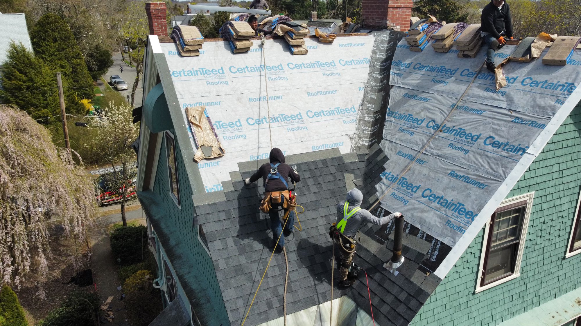 Aerial view of a completed architectural shingle roof installed by Storm King Roofing on a home in Duxbury, MA