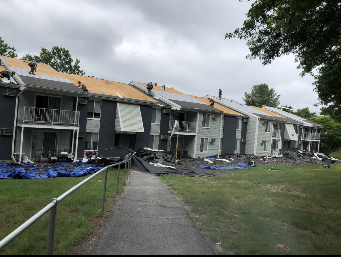 Storm King Roofing crew replacing the roof on a large multi-family apartment complex in Whitman, MA